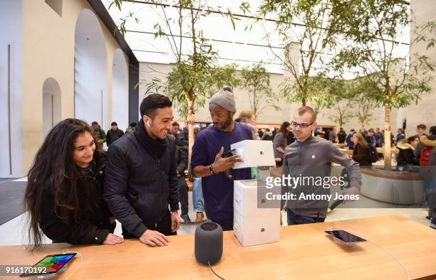 Customers look at The Apple HomePod, which is now available in stores in the US, UK and Australia, at Apple Store on Regent Street on February 9,...