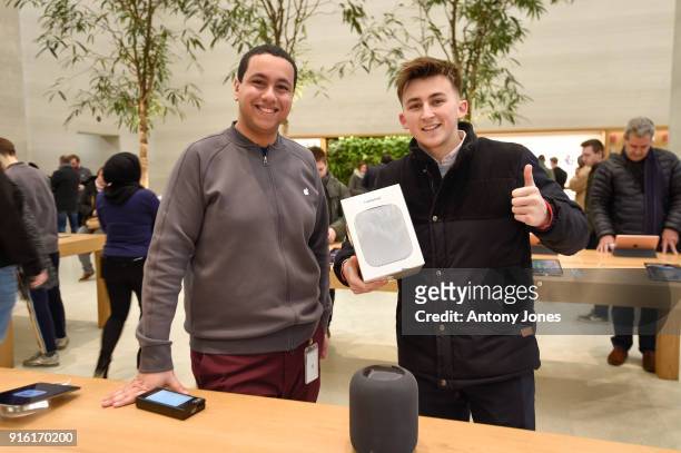 Customers pose with The Apple HomePod, which is now available in stores in the US, UK and Australia, at Apple Store on Regent Street on February 9,...