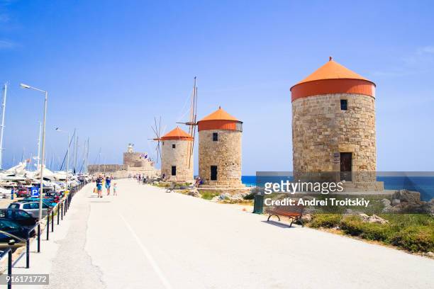 mandraki harbour with windmills, rhodes, greece - rhodes,_new_south_wales stock pictures, royalty-free photos & images