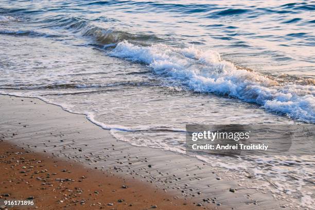 shore of aegean sea, rhodes, greece - stack of sun lounges stock pictures, royalty-free photos & images