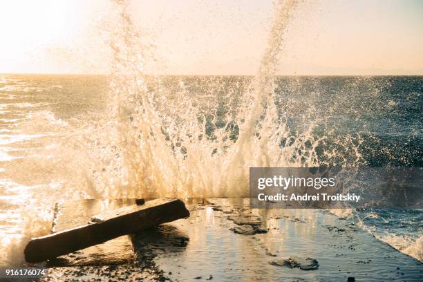 waves at the shore of aegean sea, rhodes, greece - stack of sun lounges stock pictures, royalty-free photos & images