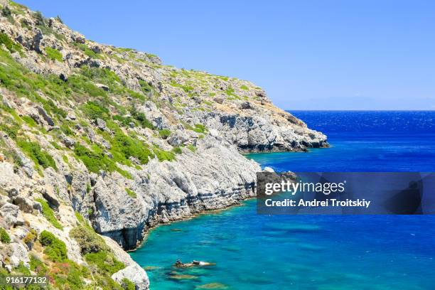 a view of a azzure water and rocky coastline near anthony quinn bay, faliraki, greece - anthony quinn bay stock pictures, royalty-free photos & images