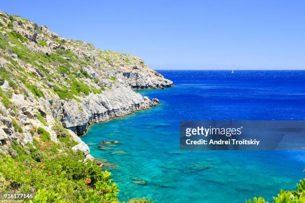 a view of a azzure water and rocky coastline near anthony quinn bay, faliraki, greece - anthony quinn bay stock pictures, royalty-free photos & images