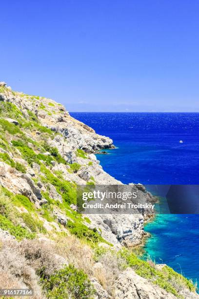 a view of a azzure water and rocky coastline near anthony quinn bay, faliraki, greece - anthony quinn bay stock pictures, royalty-free photos & images