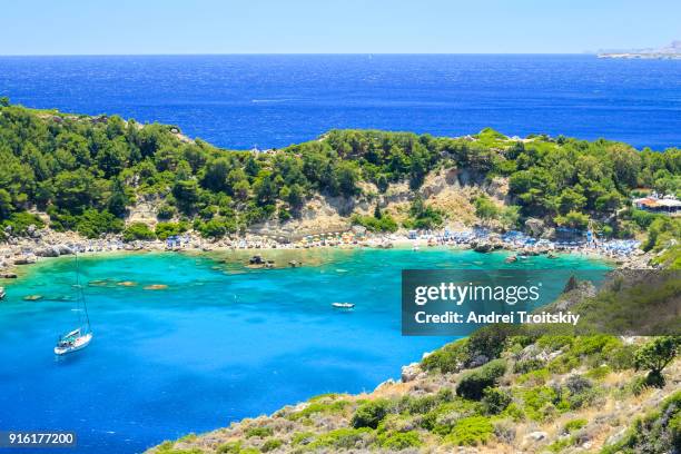 view of anthony quinn bay near faliraki village, rhodes, greece - anthony quinn bay stock pictures, royalty-free photos & images