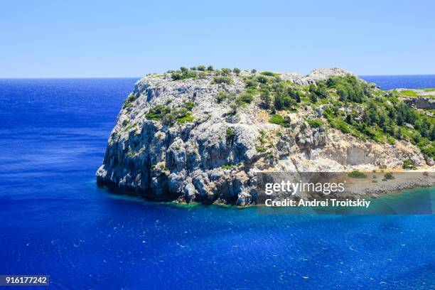 a view of a azzure water and rocky cliff near anthony quinn bay, faliraki, greece - anthony quinn bay stock pictures, royalty-free photos & images