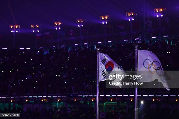 The South Korean and Olympic flags fly during the Opening Ceremony of the PyeongChang 2018 Winter Olympic Games at PyeongChang Olympic Stadium on...