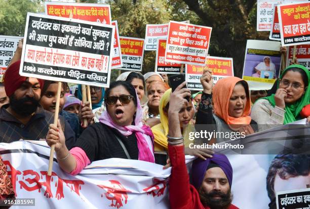 Protestors carry placards demanding arrest of Congress leader Jagdish Tytler for his alleged involvement in the 1984 anti-Sikh riots in New Delhi....