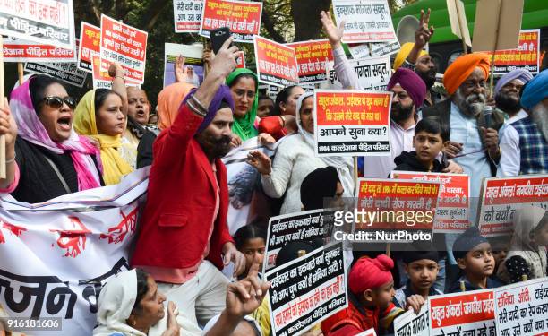 Protestors carry placards demanding arrest of Congress leader Jagdish Tytler for his alleged involvement in the 1984 anti-Sikh riots in New Delhi....