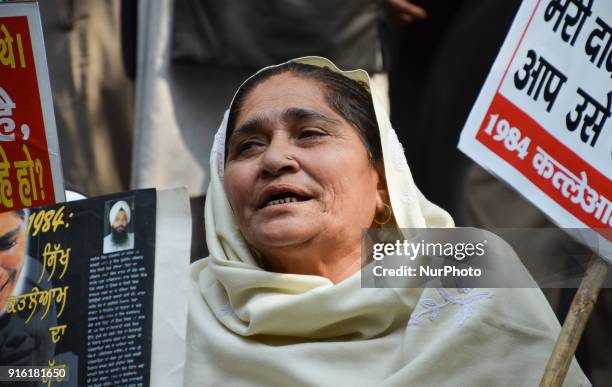 Protestor sits holding a placards demanding justice for victims in the 1984 Anti-Sikh riots. New Delhi, 9th February, 2018.