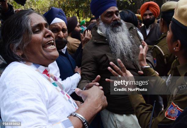 Protestors are stopped by Delhi police officials as they protest to demand arrest of Congress leader Jagdish Tytler for his alleged involvement in...