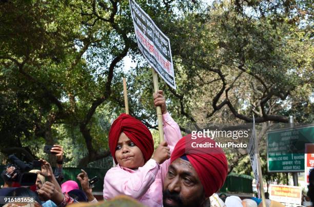 Protestors carry placards demanding arrest of Congress leader Jagdish Tytler for his alleged involvement in the 1984 anti-Sikh riots in New Delhi....