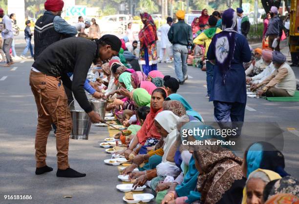 Sikh community members serve 'langar' or lunch along Akbar road to demonstrators who gathered to demand arrest of Congress leader Jagdish Tytler for...