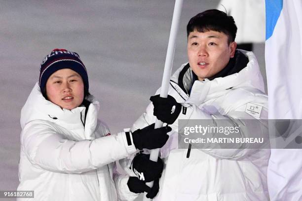 Unified Koreas flagbearer Hwang Chung Gum and Unified Koreas flagbearer Won Yun-jong lead the delegation parade during the opening ceremony of the...