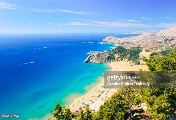view of tsambika beach from the hill near tsambika church, rhodes, greece - rhodes,_new_south_wales stock pictures, royalty-free photos & images