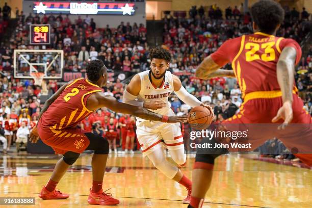 Cameron Lard of the Iowa State Cyclones knocks the ball away from Brandone Francis of the Texas Tech Red Raiders during the game on February 7, 2018...