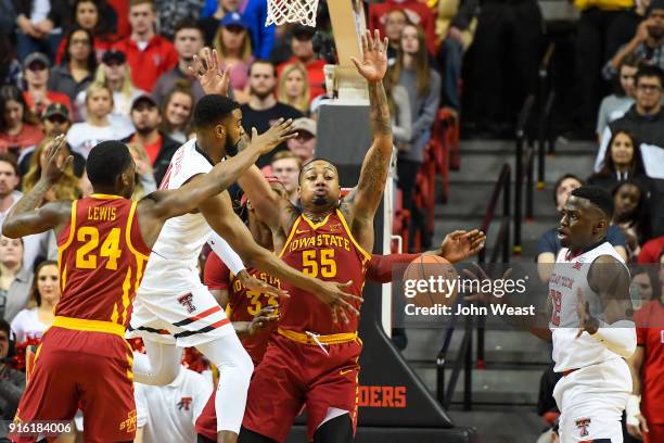 Niem Stevenson of the Texas Tech Red Raiders passes the ball to teammate Norense Odiase while guarded by Jeff Beverly of the Iowa State Cyclones...