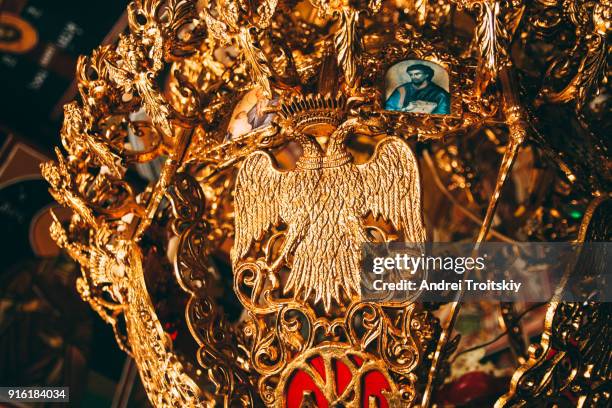 gold plated old chandelier with two-headed eagle silhouette at little christian church, greece - aquila heliaca stock pictures, royalty-free photos & images