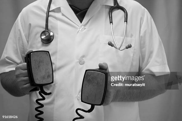 doc on work - electroshock stock pictures, royalty-free photos & images