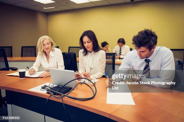 business people at desk in conference - master of business administration stock pictures, royalty-free photos & images