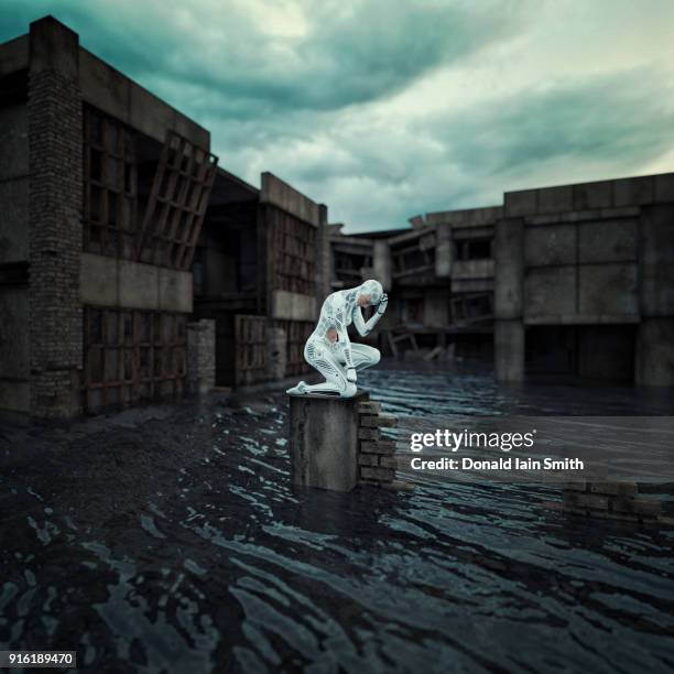 robot kneeling on broken wall in flood - natural disaster photos et images de collection