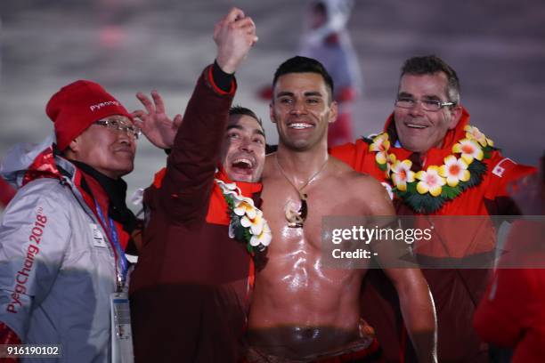 Tonga's flagbearer Pita Taufatofua takes a selfie as his country's delegation parades during the opening ceremony of the Pyeongchang 2018 Winter...