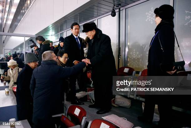 North Korea's Kim Jong Un's sister Kim Yo Jong watches as North Korea's ceremonial head of state Kim Yong Nam shakes hands with President of the...