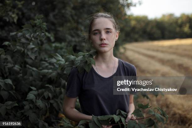 portrait of caucasian teenage girl holding branch - girl headshot stock pictures, royalty-free photos & images