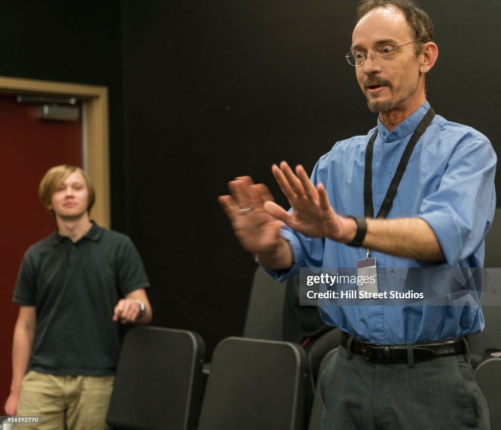 Teacher gesturing in theater class