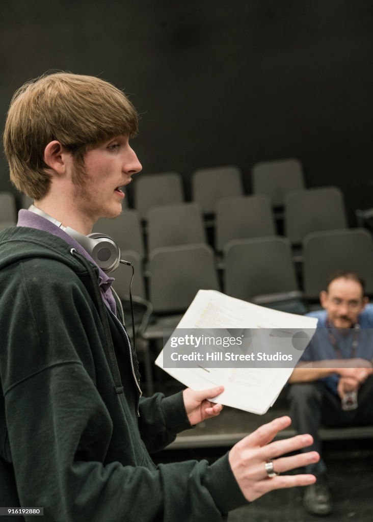 Teacher listening to student reading script