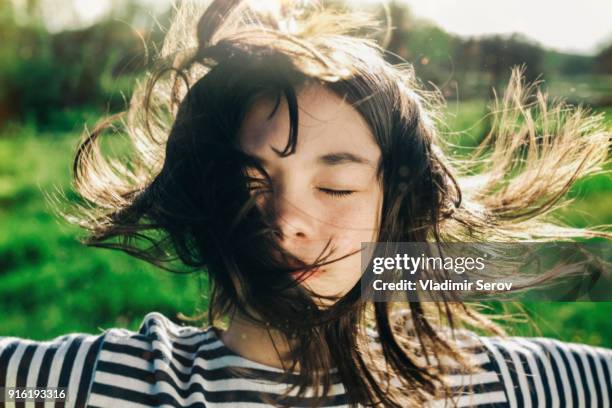 wind blowing hair of caucasian teenage girl - flatterndes haar stock-fotos und bilder