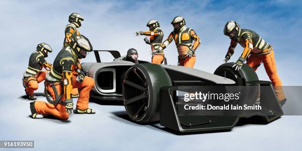 futuristic pit crew servicing race car - pit crew challenge imagens e fotografias de stock