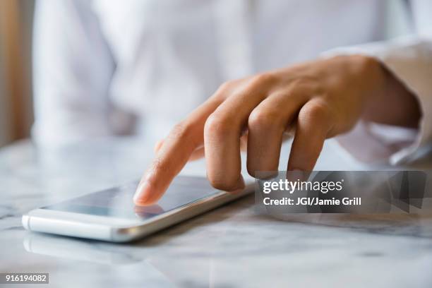 finger of african american woman using cell phone - tapping stock-fotos und bilder