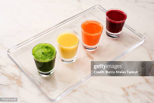 juice shot variations - ginger glasses stock-fotos und bilder