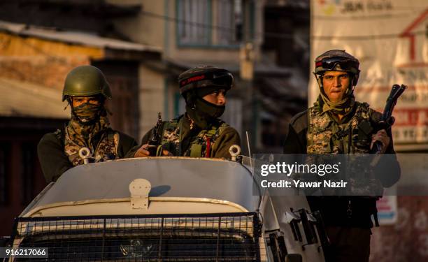 Indian paramilitary troopers withdraw from the restriction bound areas in the old city as Kashmiri Muslim protesters chase them with bricks and...