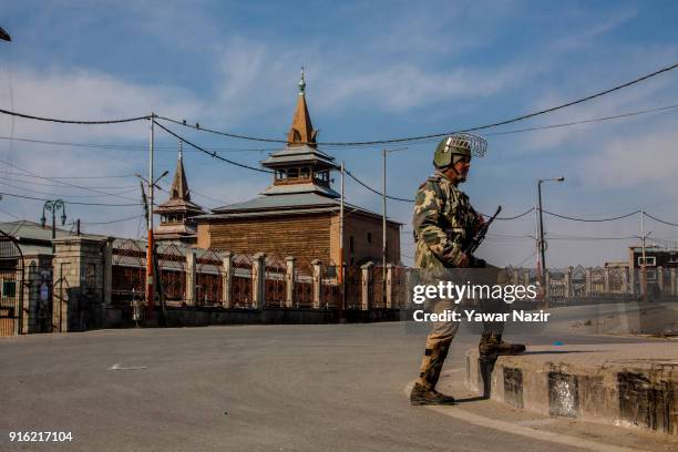 An Indian paramilitary trooper stands guard, in front Kashmir's Jamia Masjid in the Old City during restrictions on the fifth death anniversary of...