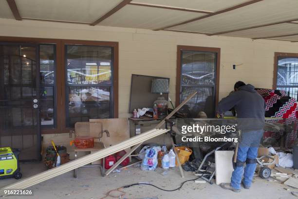 Worker measures a wood plank while remodeling a home destroyed by Hurricane Harvey in Houston, Texas, U.S., on Friday, Jan. 19, 2018. Houston has...