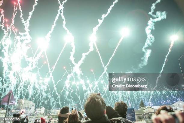 Spectators watch a fireworks display during the opening ceremony of the 2018 PyeongChang Winter Olympic Games in the Hoenggye-ri village area of...