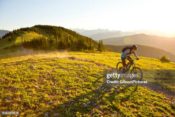 sunset mountain bike ride - extreme sports bike stock pictures, royalty-free photos & images