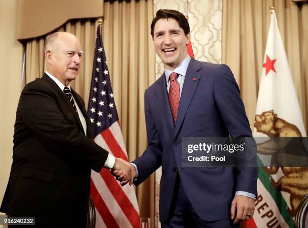 Canada's Prime Minister Justin Trudeau, right, shakes hands with California Governor Jerry Brown during a meeting on February 9, 2018 in San...