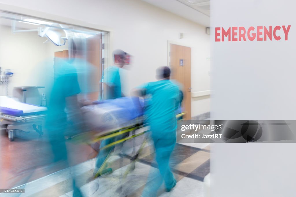 Doctor wheeling patient