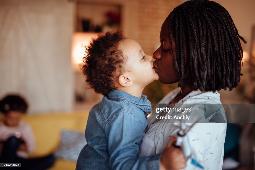 Mom and daughter kissing