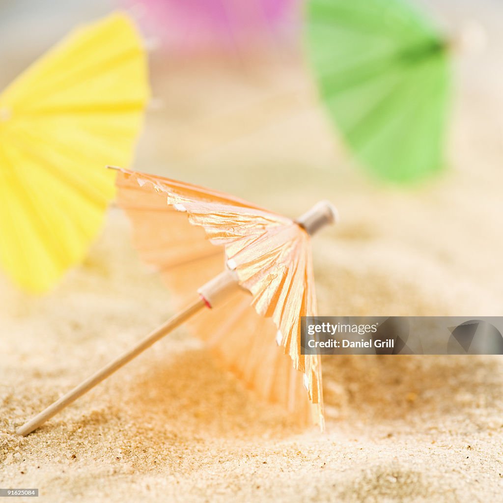 Drink umbrellas on sand