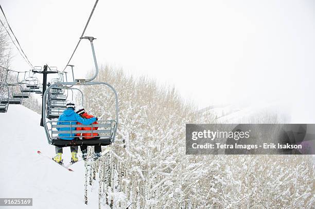 skiers on a ski lift - utah stock photos et images de collection