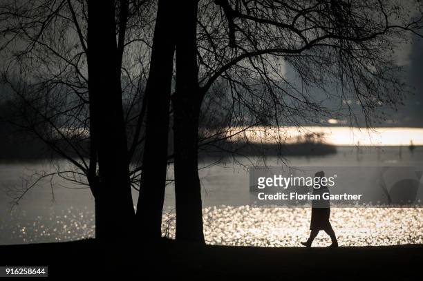 Woman walks along the Havel river during sunset on February 09, 2018 in Berlin, Germany.