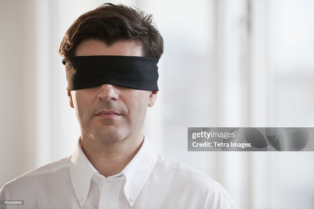 Businessman wearing blindfold