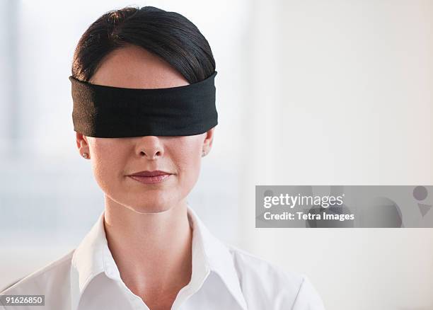 businesswoman wearing blindfold - blinddoek stockfoto's en -beelden