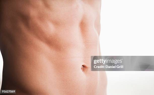 a man's shirtless abdomen - belly button stock pictures, royalty-free photos & images