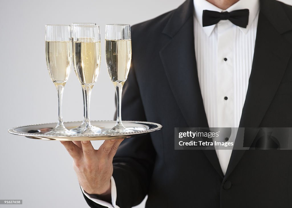 Champagne being served on a silver tray