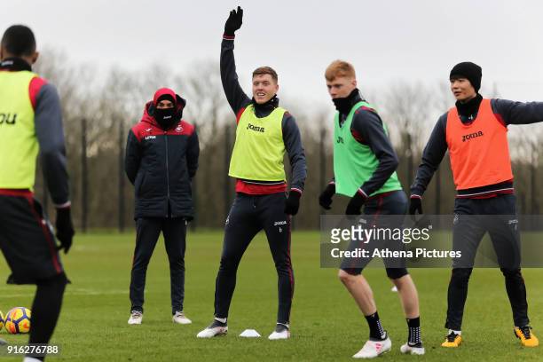 Coach Bruno Lage with players Alfie Mawson, Sam Clucas and Ki Sung-Yueng in action during the Swansea City Training and Press Conference at The...